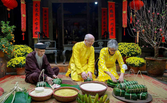 Du khách quốc tế trải nghiệm gói bánh chưng đón Tết Nguyên Đán ở Việt Nam. (Nguồn ảnh: Cục Du lịch Quốc gia) w-77-dai-su-quoc-te-trai-nghiem-tet-xu-doai-pham-ngoc-diep-0965461565.jpg